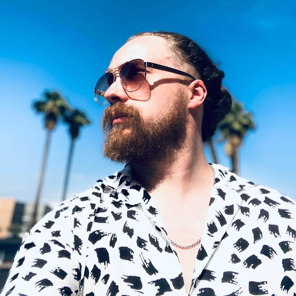 Behind the scenes interview with Christopher Shayne about the song NiceRide in a sunny setting with palm trees.