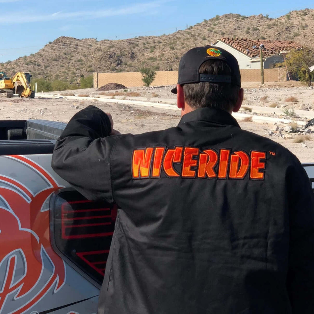 Person wearing a Niceride jacket outdoors, showcasing unisex outerwear designed for comfort and style.