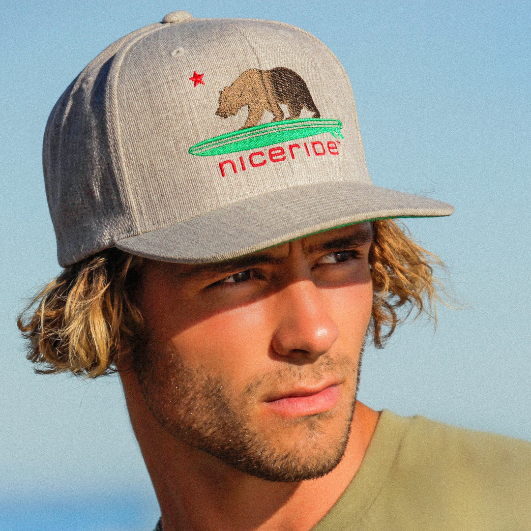 Fitted hats with water droplets showcasing bold embroidery, perfect for hats lovers looking for stylish weather-resistant options.