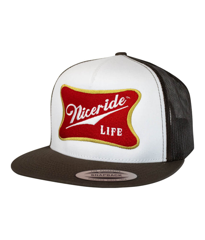 Biscuit Trucker Hat featuring embroidered design and palm logo, perfect stylish hat for casual wear.