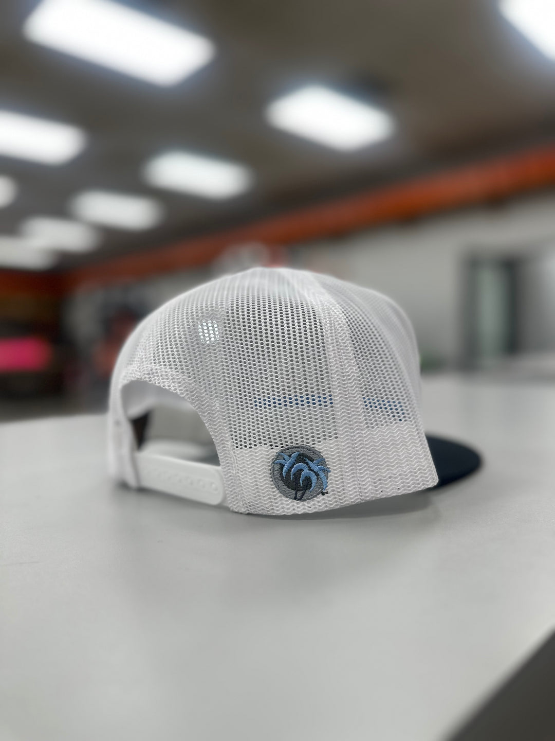 Back view of a Low Tide trucker hat showing NICERIDE&