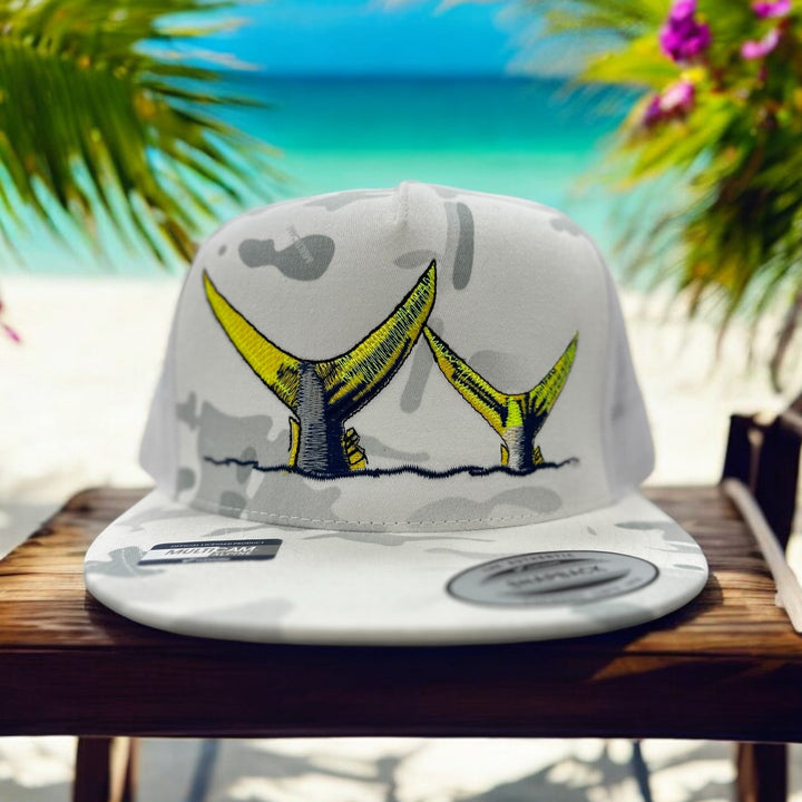 NICERIDE Tall Tails trucker hat with yellow tail design, set against a beach backdrop, unisex baseball cap.