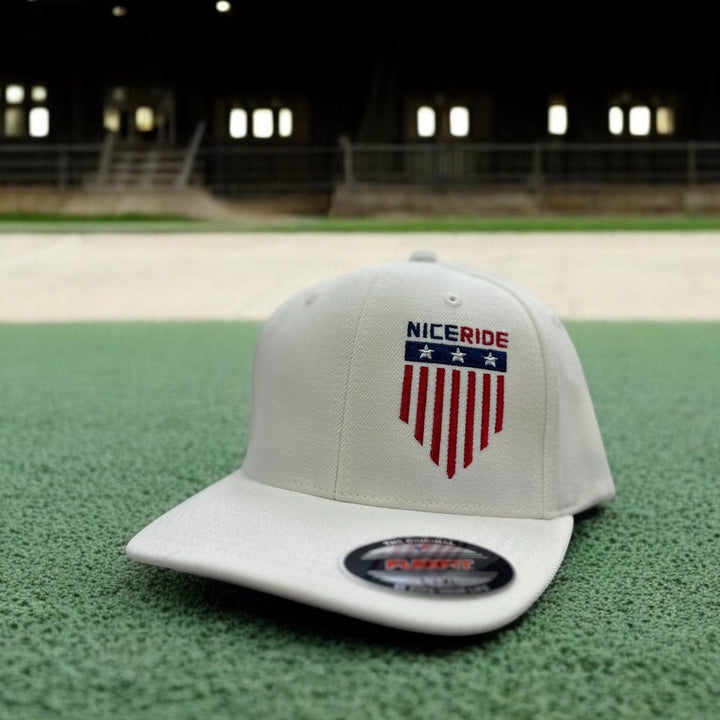 NICERIDE baseball cap featuring an embroidered logo on a gray background, set on green turf.