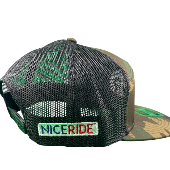 Back view of NICERIDE camo/black unisex 7 panel trucker hat showcasing mesh design and embroidered logo.