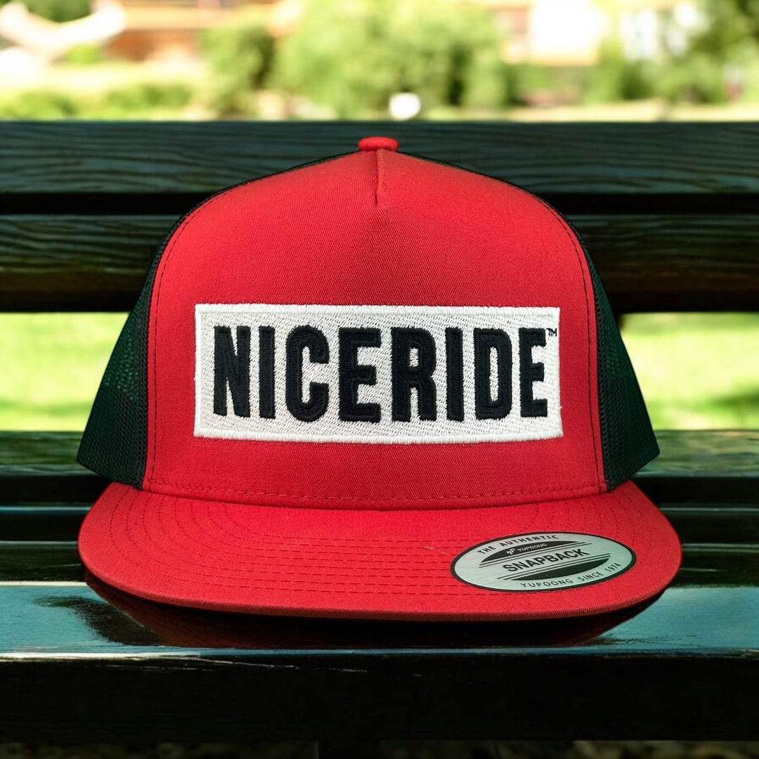 Red NICERIDE trucker hat with adjustable black mesh sides, perfect for a stylish casual look.