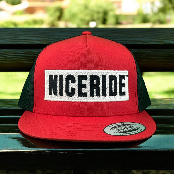 Red NICERIDE trucker hat with adjustable black mesh sides, perfect for a stylish casual look.