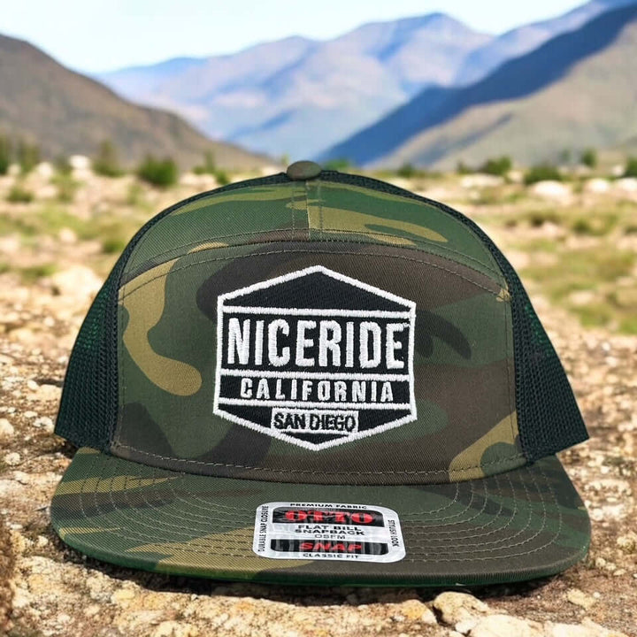 NICERIDE camouflage snapback hat with logo, set against a mountainous outdoor background.