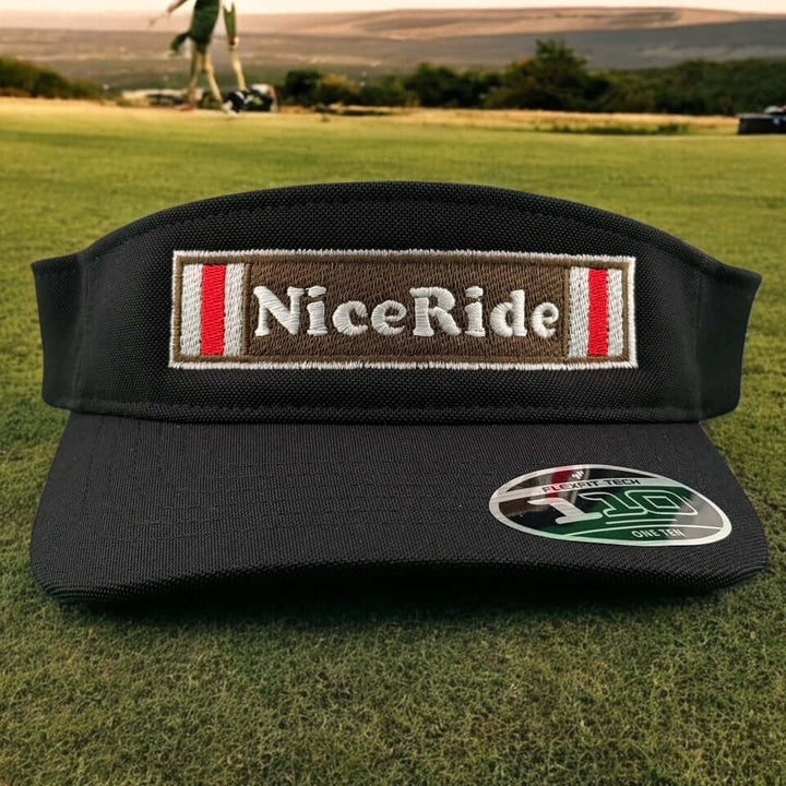 Black unisex adjustable golf visor with NiceRide logo on the front, set on a green golf course backdrop.