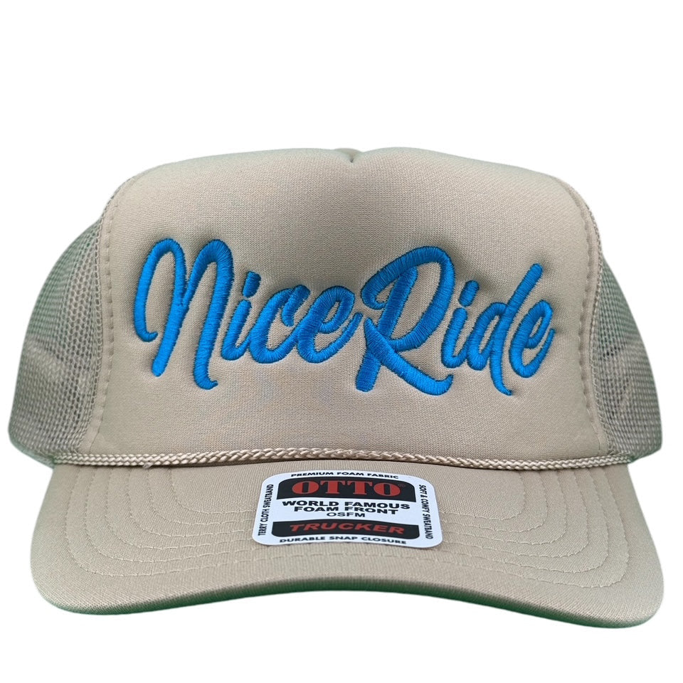 "Signature" Foam Trucker Hat featuring NICERIDE logo in blue on a beige front panel.