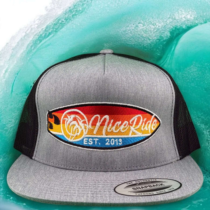 NICERIDE "Dukes" unisex adjustable trucker hat in gray with colorful logo on wave background.