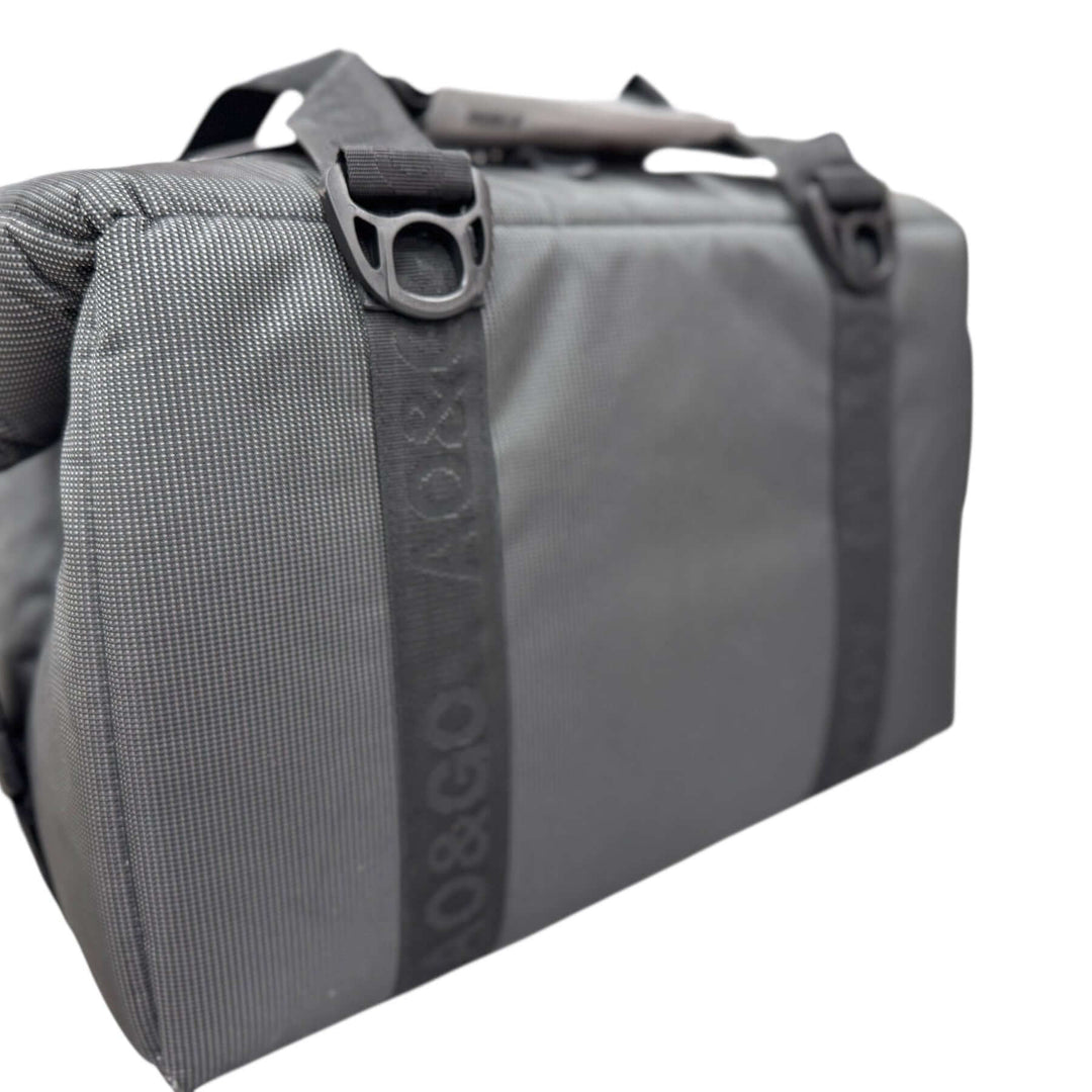 Side view of the MUD embroidered cooler, showcasing its durable gray fabric and sturdy straps.