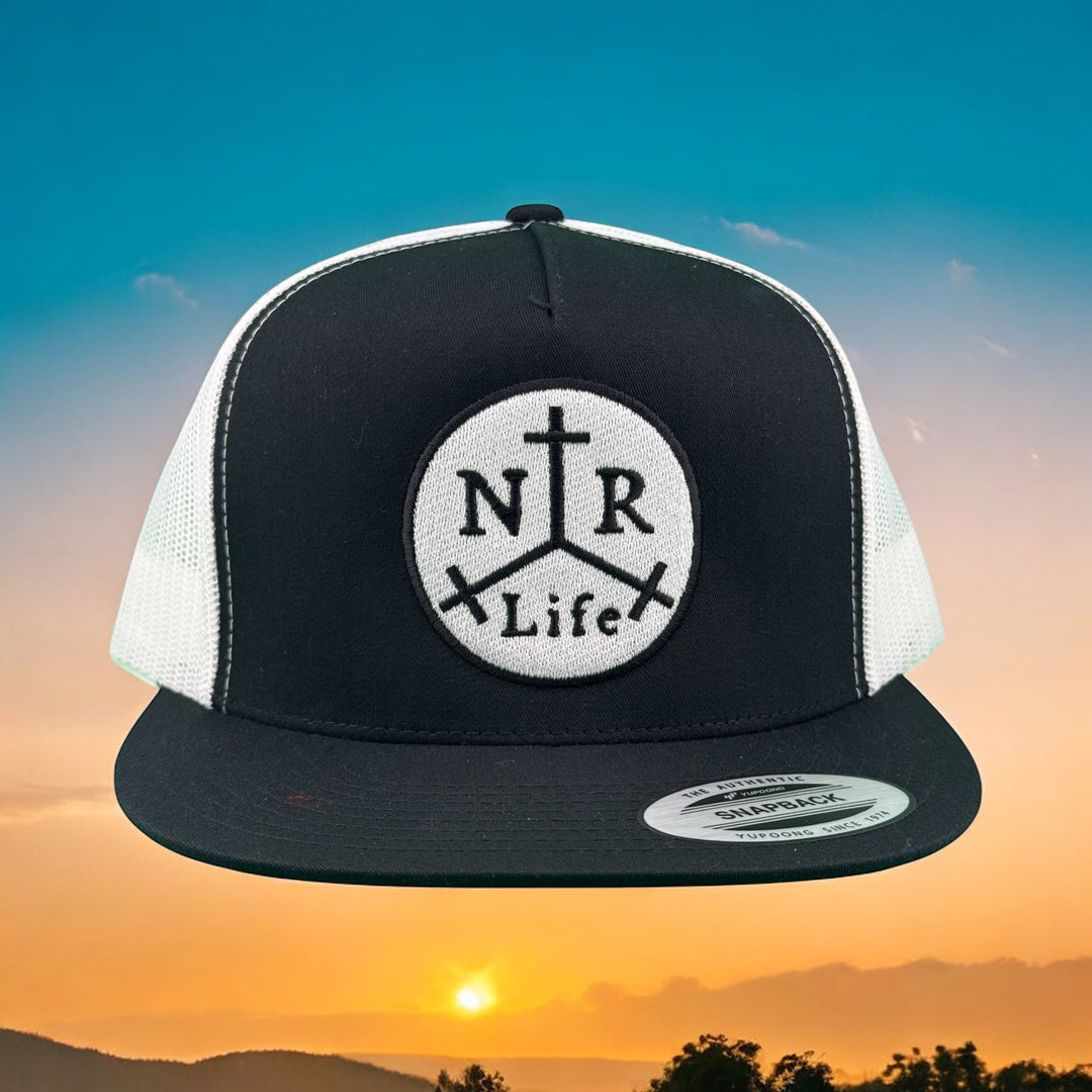 Black and white unisex adjustable trucker hat with embroidered NTR Life logo, set against a sunset backdrop.