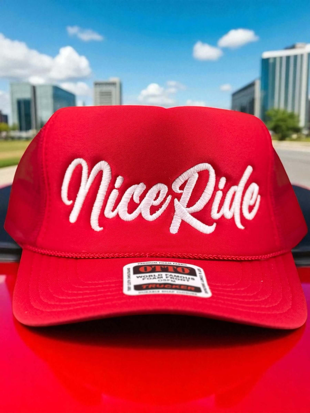 Red foam trucker hat featuring embroidered &