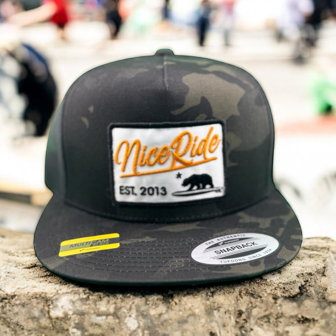 Big Sky unisex snapback trucker hat featuring camouflage design and NiceRide logo, perfect for outdoor style.