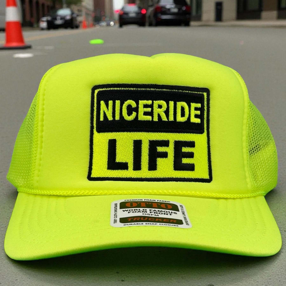 NICERIDE "Caution" Otto Unisex Foam Trucker Hat with embroidered logo on a vibrant yellow background.