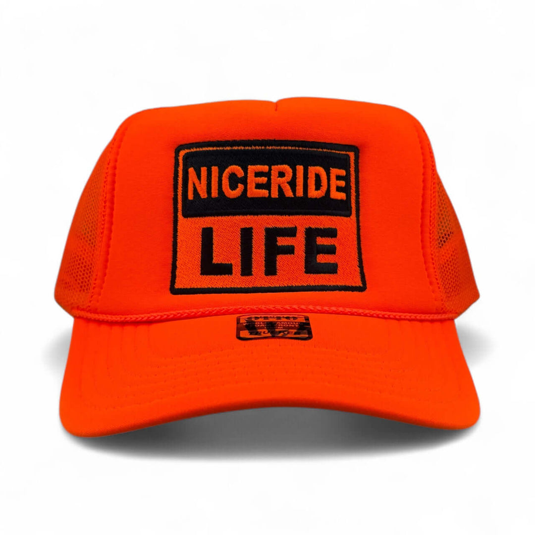 NICERIDE “Caution” Otto unisex foam trucker hat in bright orange with bold black embroidered logo.