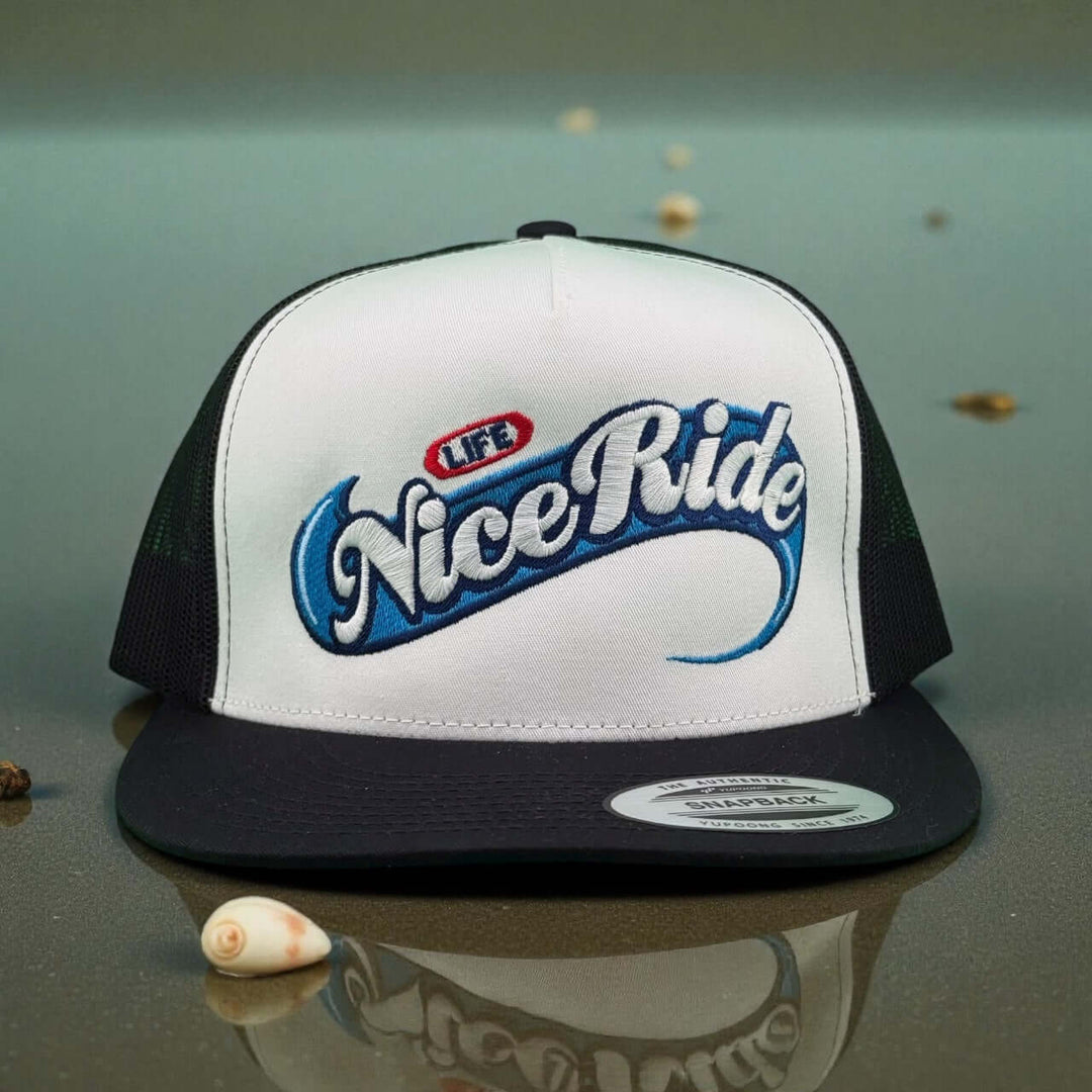 Niceride Life adjustable trucker hat featuring stylish embroidery in blue and red on a white and black cap.