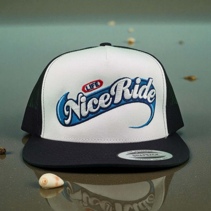 Niceride Life adjustable trucker hat featuring stylish embroidery in blue and red on a white and black cap.