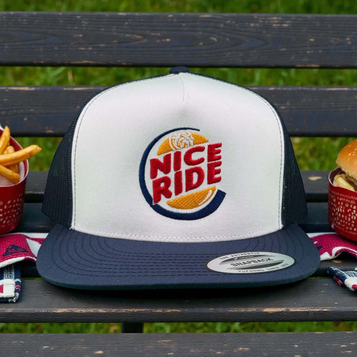 NICERIDE unisex adjustable trucker hat with logo on a picnic table, ideal casual hat for style and comfort.