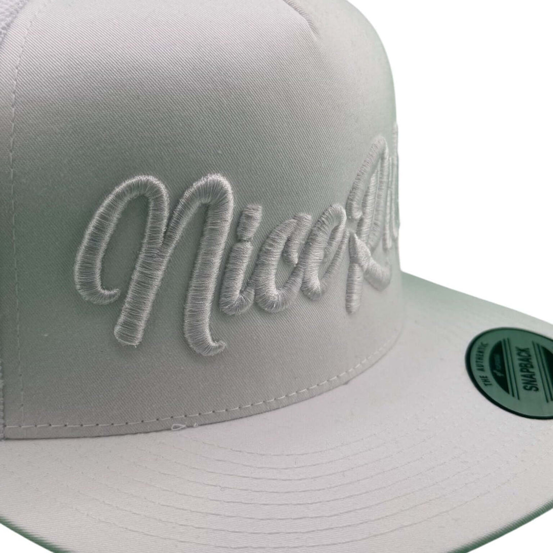 Close-up of the NICERIDE "Signature" 3D Puff hat showcasing white embroidered design on front panel.