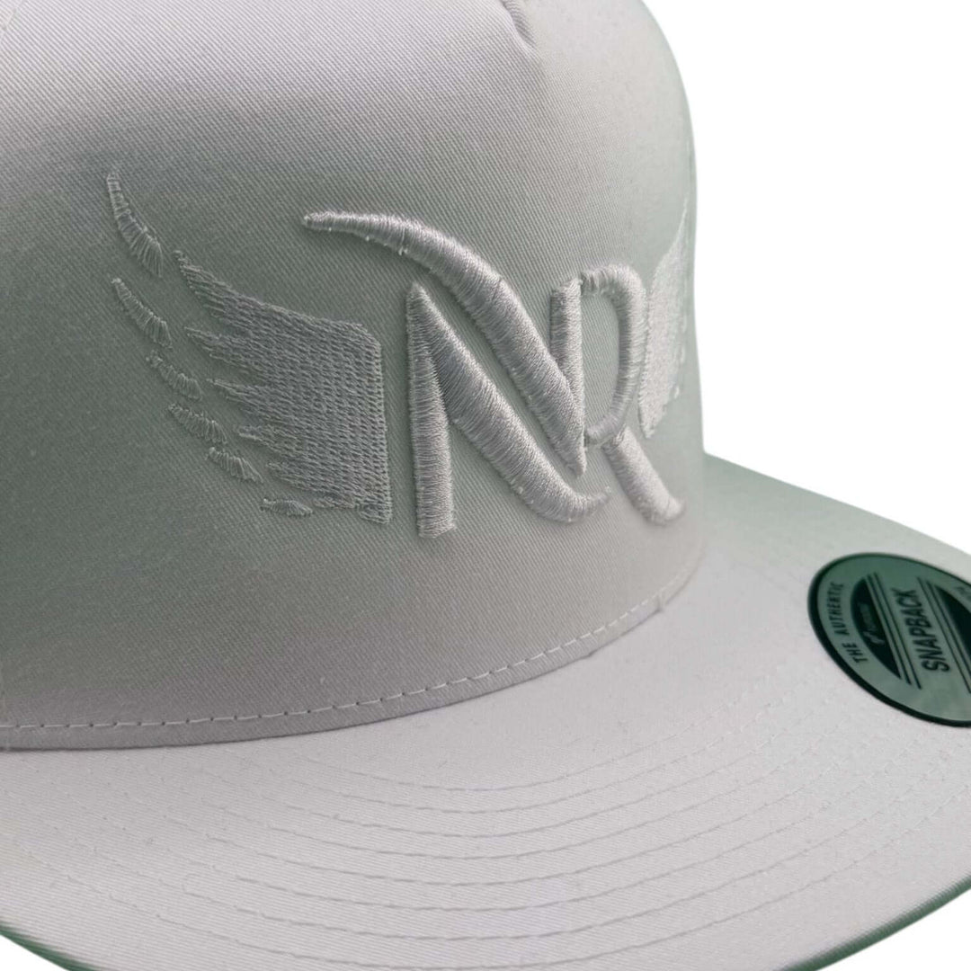 "Soaring" 3D White Puff unisex adjustable trucker hat featuring elevated NR logo embroidery.