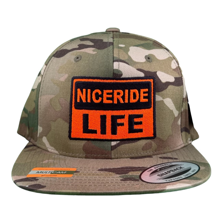 NICERIDE “CAUTION” unisex adjustable Multicam trucker hat showcasing LIFE logo on the front with camo pattern.
