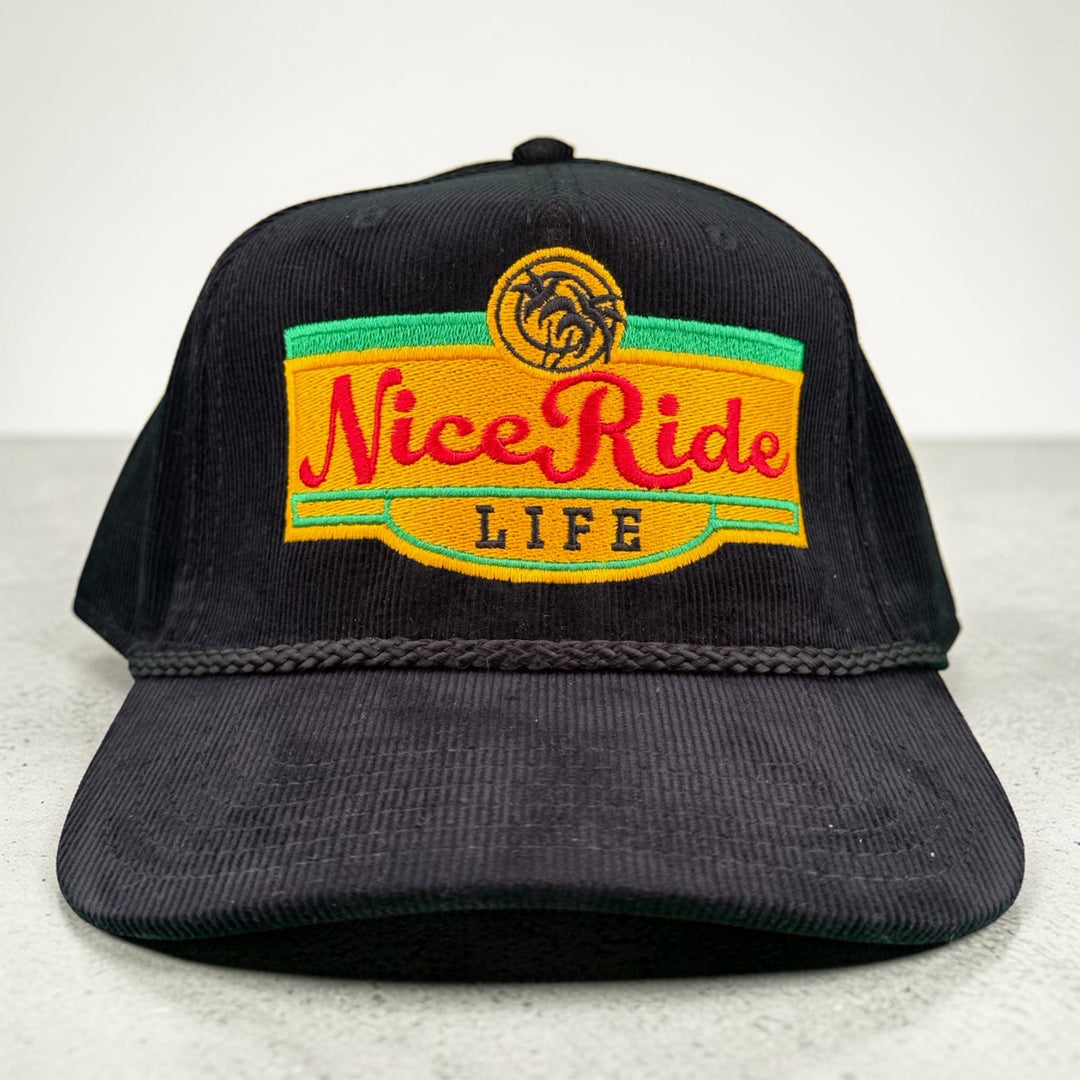 Black Corduroy OTTO CAP 5 Panel Snapback Baseball Cap featuring NiceRide LIFE logo, perfect hat for outdoor adventure and street style.