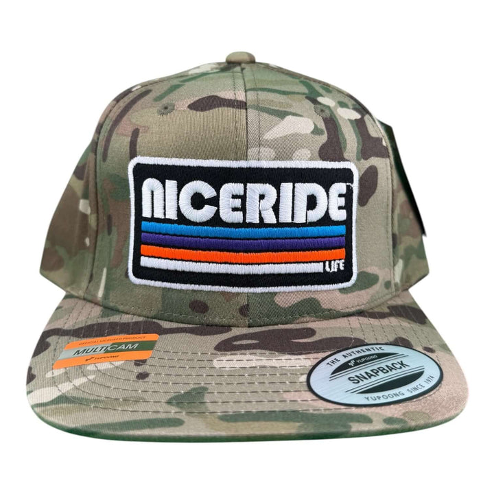 NICERIDE "TRIGGER" 6089 unisex adjustable multicam trucker hat with logo on camo background.