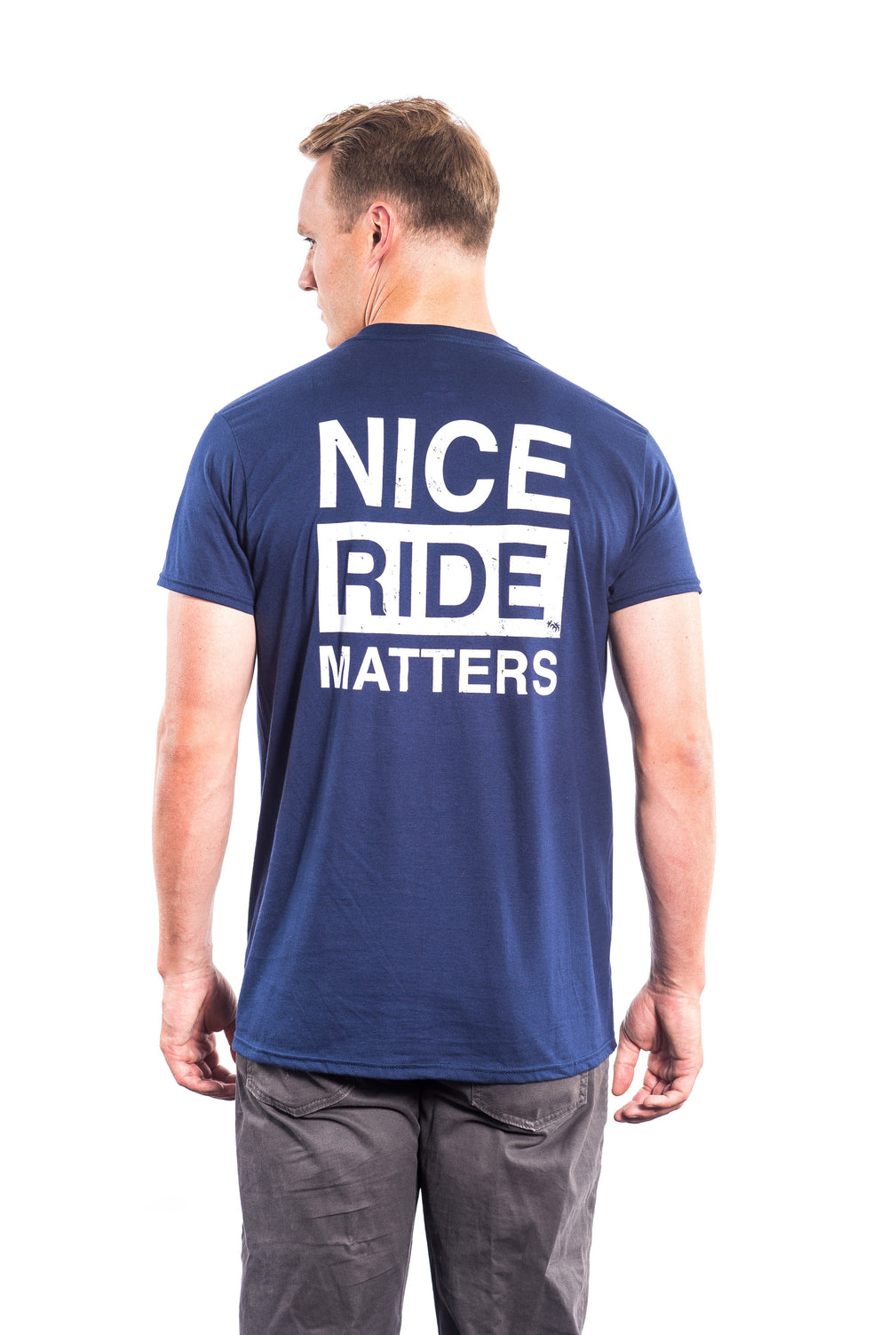 Back view of a man wearing a blue shirt with 'NICE RIDE MATTERS' printed, showcasing the shirt design.