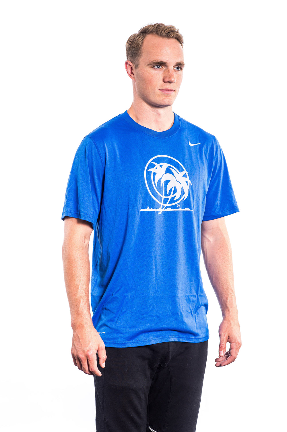 Classic Palm - NIKE Dri-Fit shirt in blue worn by a model standing against a white background.