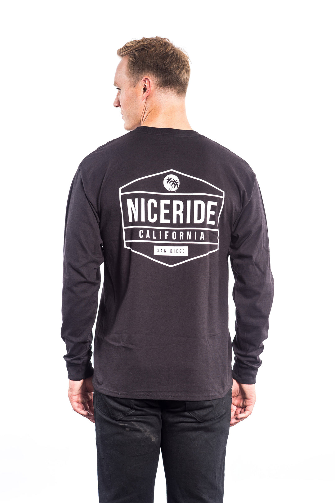 Back view of a man wearing a black long sleeve shirt with NICERIDE logo, showcasing the shirt design.