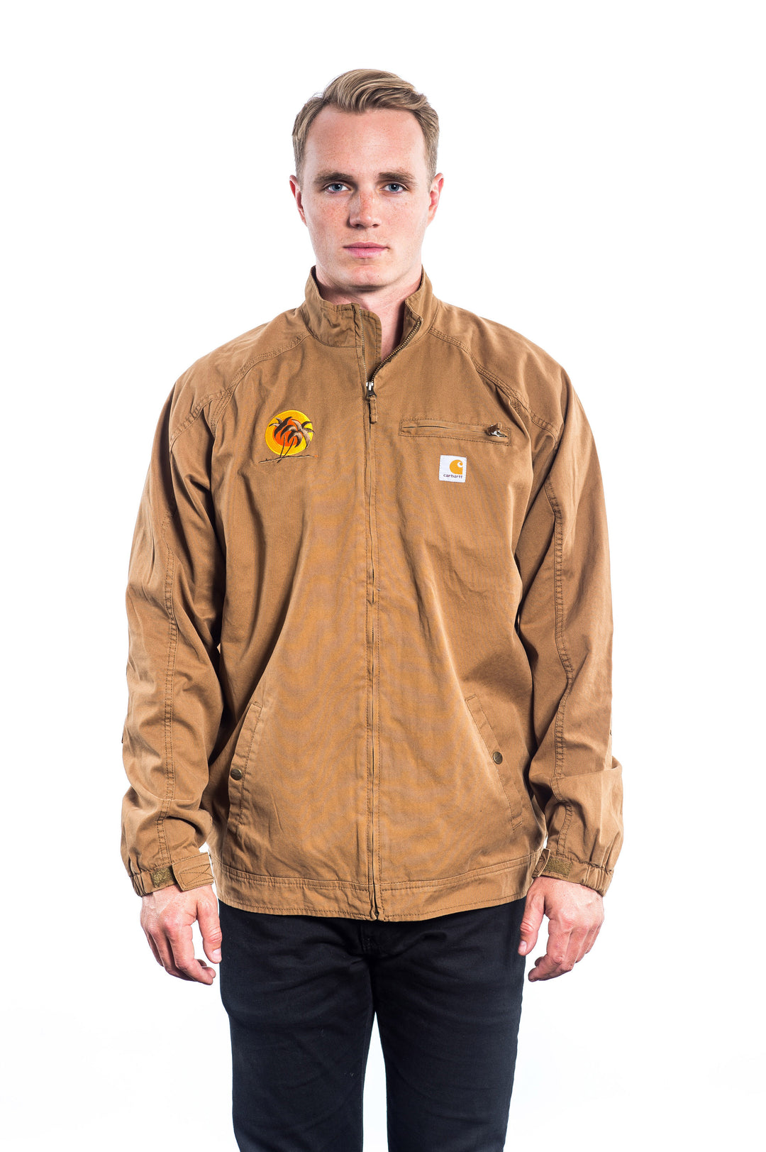 Big Country jacket by Carhartt in brown with embroidered logo on chest, model wearing it.