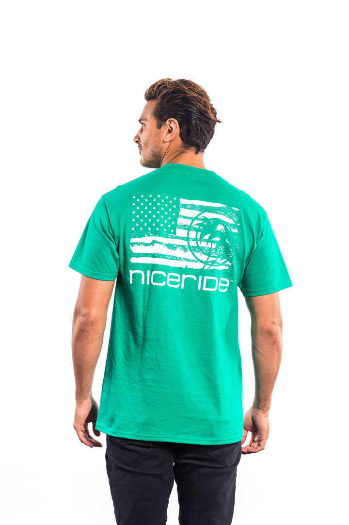 Man wearing a green shirt featuring the American flag and nicerride design, showcasing the back of the shirt.