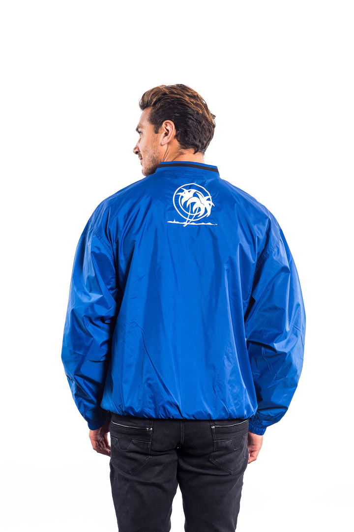 Back view of a man wearing a blue windbreaker pullover with Classic Palm logo embroidered on the back.