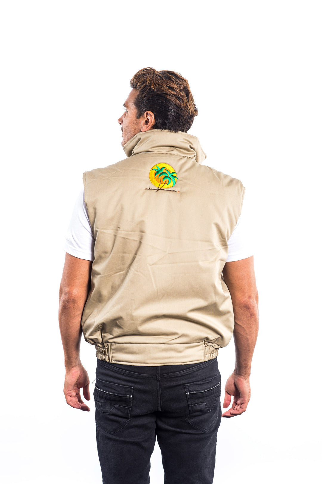 Man wearing a beige cargo vest featuring NICERIDE embroidery on the left chest and classic palm logo on the back.