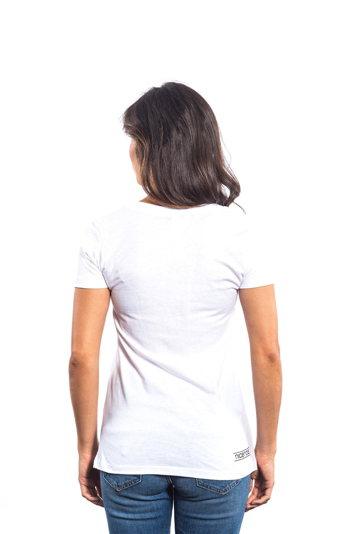 Back view of a woman wearing a La Jolla white shirt with short sleeves and a v-neck design.