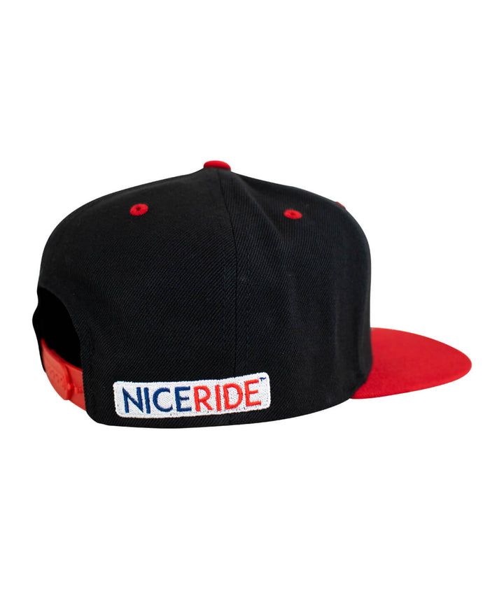 Back view of "Buck-Eye Glory" unisex flatbill snapback hat by NICERIDE, showcasing logo and red brim.