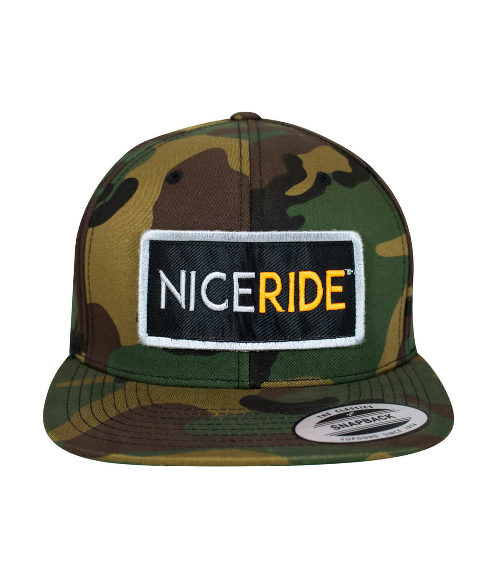 N-R Patch snapback hat featuring a camouflage design and embroidered NICE RIDE patch on the front panel.