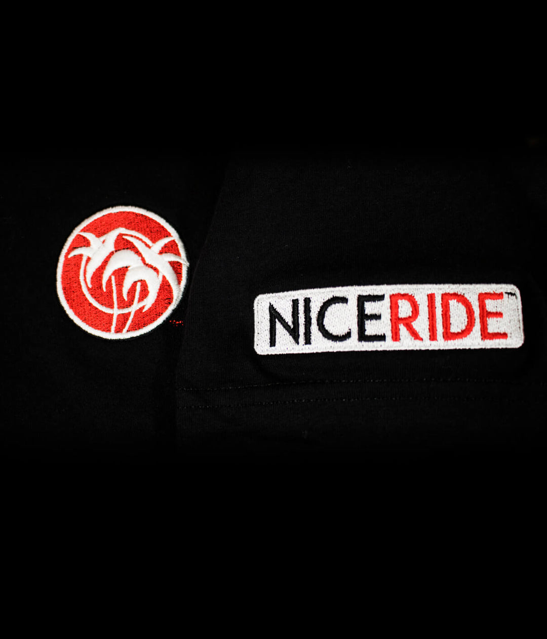Embroidered logo details of NICERIDE on black short sleeve t-shirt showcasing Rojo Negro design.
