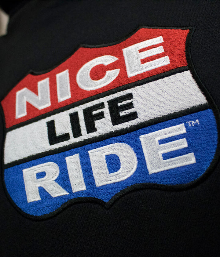 Close-up of NICERIDE logo featuring the text &