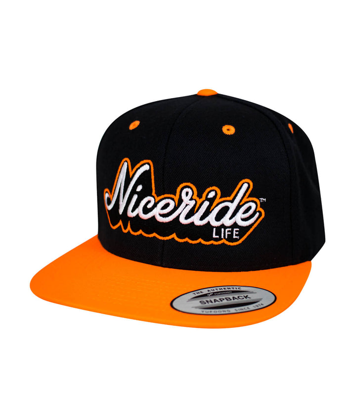 Half Pipe Flatbill Snapback Hat by NICERIDE in black and orange colors, featuring embroidered logo and snapback closure.