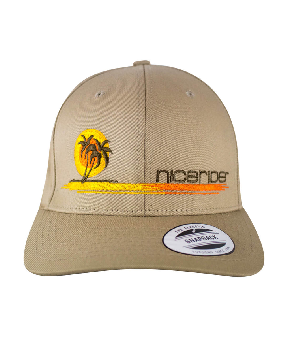 Classic Flexfit hat with NICERIDE's 'Sunset' design and palm logo embroidered in gold, brown, and orange.