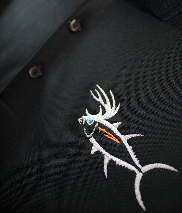 Embroidered fish design on black polo shirt, showcasing quality craftsmanship and attention to detail.