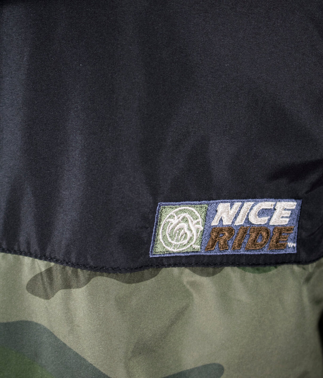 Close-up of the NICERIDE logo on the Last Hook Up lightweight windbreaker jacket featuring stylish embroidery.