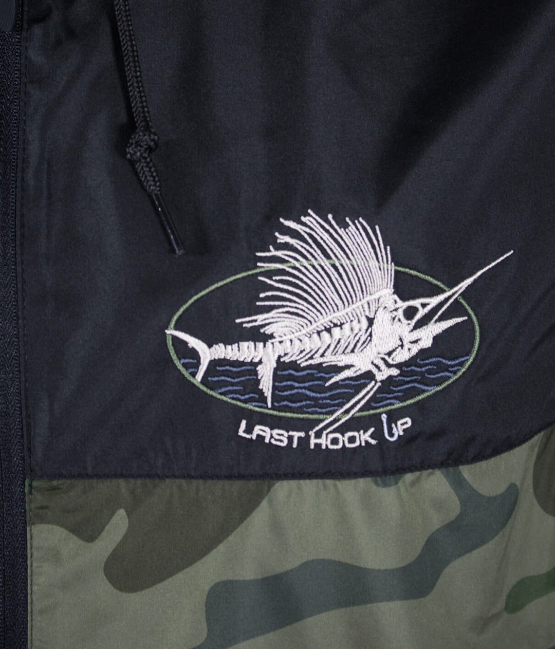 Embroidered fish design on "Last Hook Up" lightweight windbreaker jacket featuring detailing and logo.