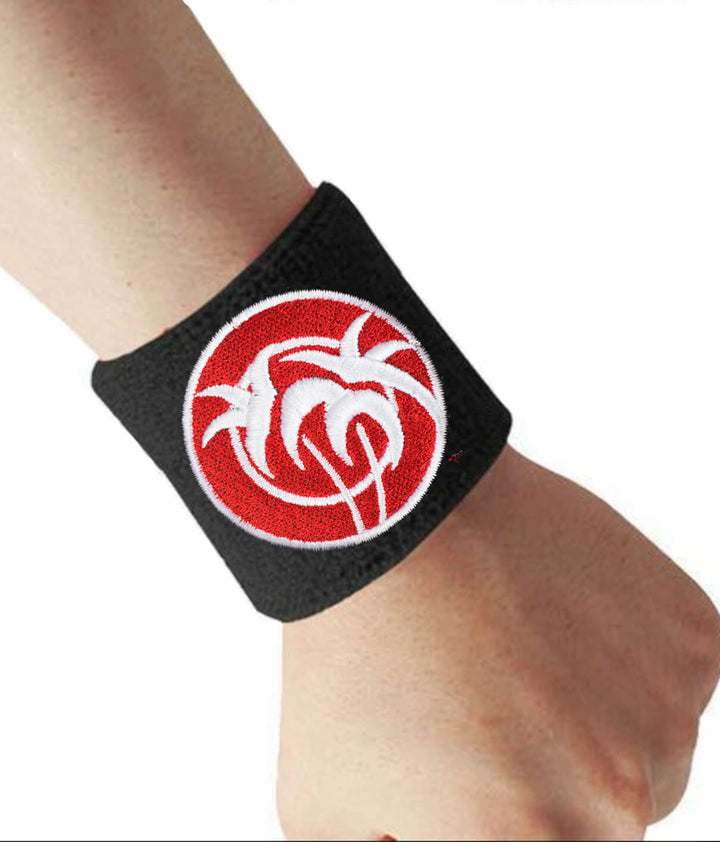 Close-up of Rojo Negro wrist sweatband showing palm tree design, ideal for athletes and musicians.