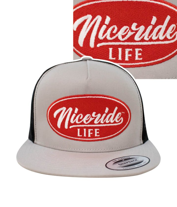 Nicride Life unisex trucker cap featuring embroidered red logo on a gray background.