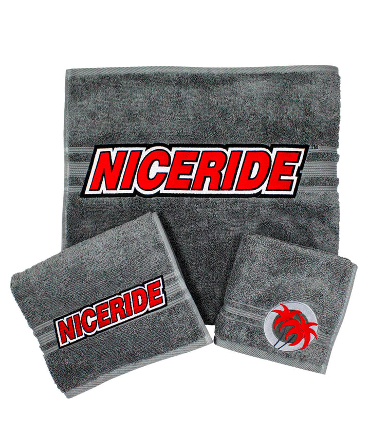 Slick 3 Piece Towel Set in gray featuring embroidered NICE RIDE logo on each towel, including body towel, hand towel, and wash cloth.