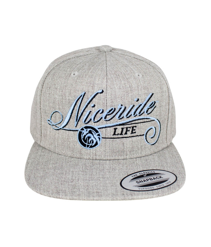The Life Snapback Hat featuring NICERIDE logo and blue embroidery on a gray background, ideal stylish hat.