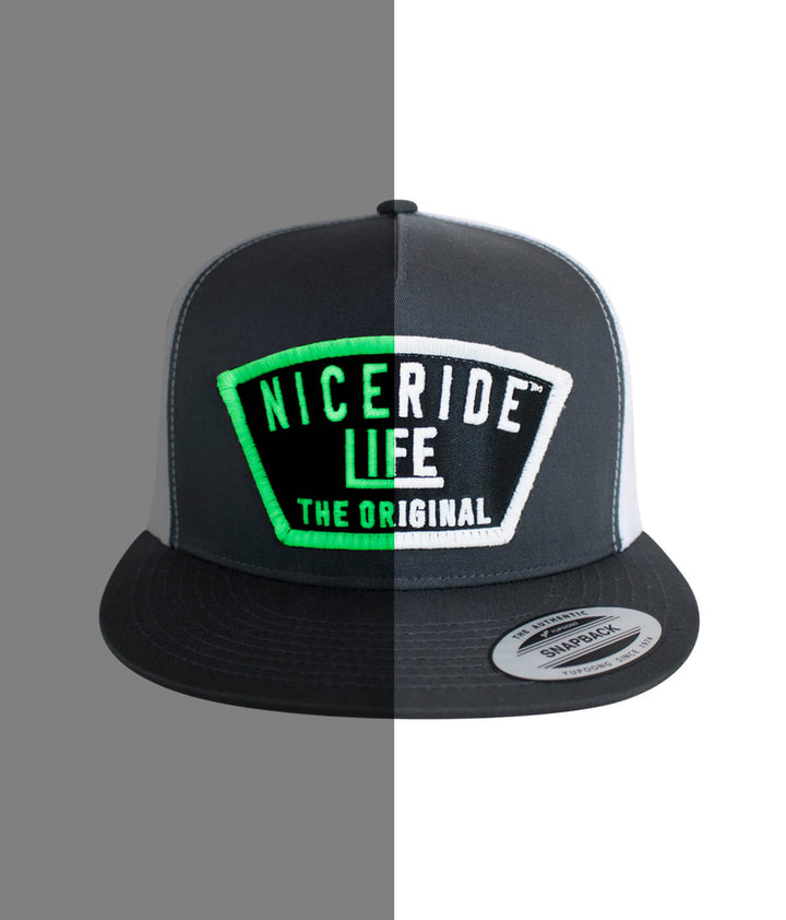 Grinder Trucker Hat featuring NICERIDE design, snapback cap with vibrant green embroidery, focus on hat design.
